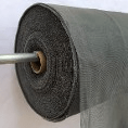 Roll of black mesh fabric on a metal rod, showcasing its texture and flexibility. Ideal for crafting, construction, or ventilation applications.