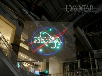 Neon display of NASA logo illuminated in a public exhibit space, highlighting the organization's impact on space exploration and science.
