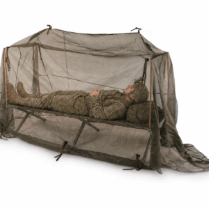 A soldier lies inside a lightweight mesh tent on a cot, demonstrating a portable sleeping solution for outdoor or military use.