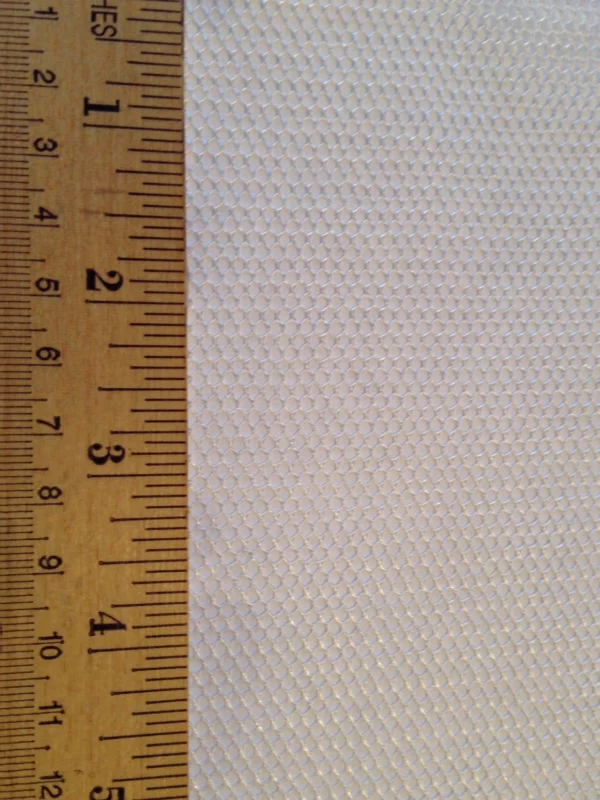 Close-up of a honeycomb-patterned material beside a wooden ruler, illustrating the texture and dimensions for crafting or design purposes.